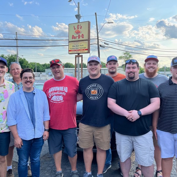 Group of ten people standing outside L.C.'s Bar-B-Q restaurant.